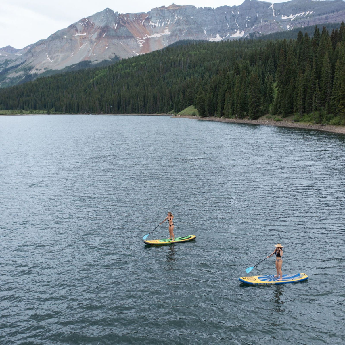 Carbon GalaXy SOLtrain Inflatable Paddle Board Two Women Standing on SUP Board Paddling